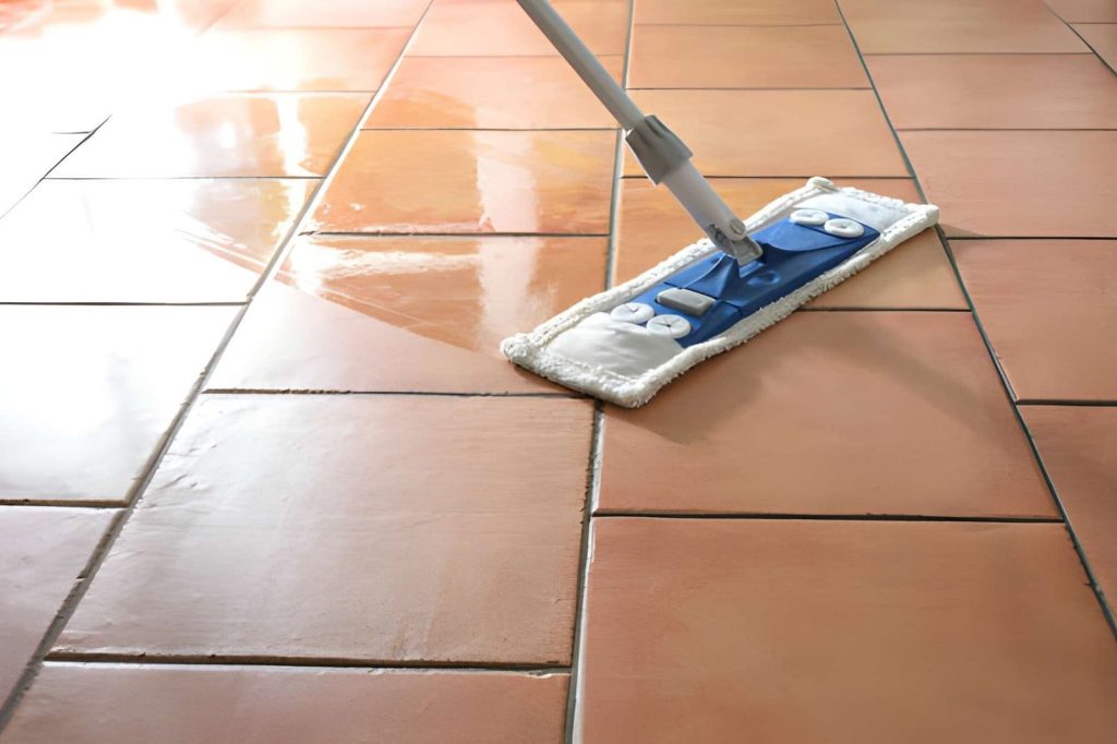 Tile cleaning Fort Pierce professional mop restoring terracotta tiles with visible clean and dry contrast